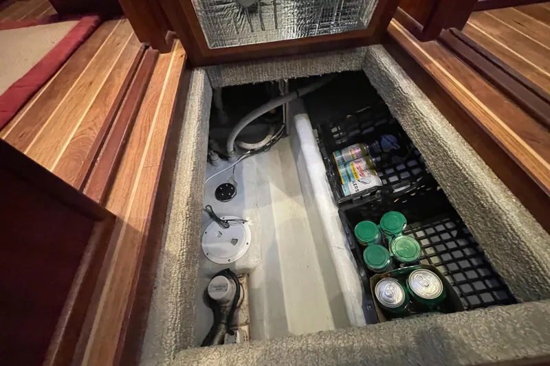 Spray Yacht Photos Pics Storage compartment in a 2015 Nordic Tug 39, featuring canned goods and utility access.