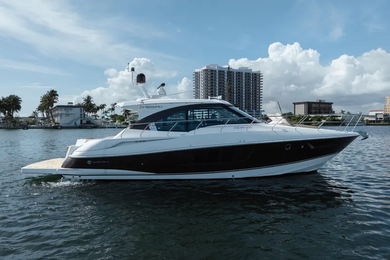 Chassan Yacht Photos Pics 2016 Cruisers Cantius yacht on water with cityscape background.