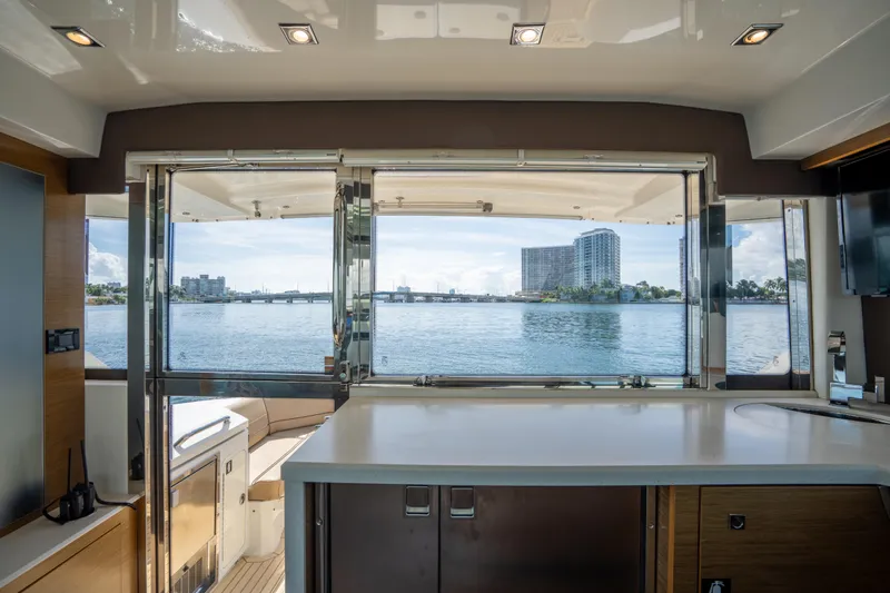 Chassan Yacht Photos Pics Interior view of 2016 Cruisers Cantius yacht with waterfront cityscape.