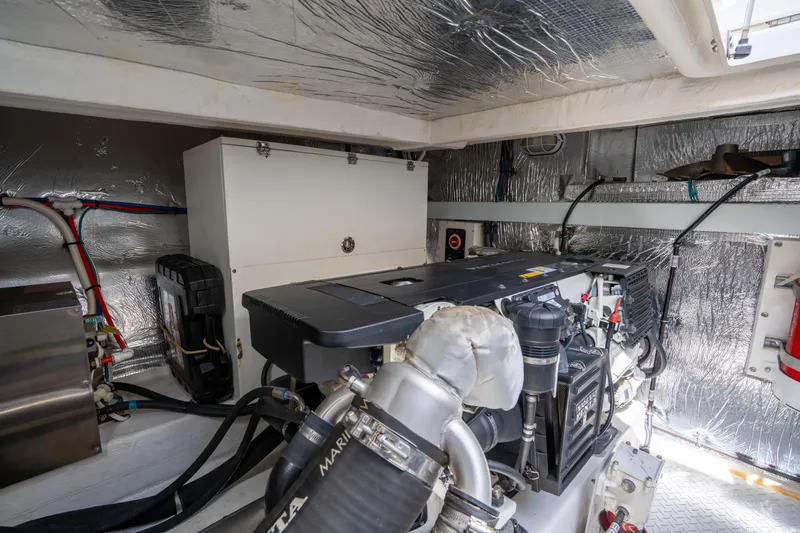 Chassan Yacht Photos Pics Engine room of a 2016 Cruisers Cantius yacht, featuring a well-maintained engine and equipment.