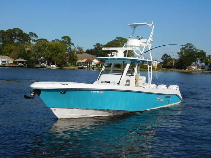  Yacht Photos Pics 2016 Everglades 355 Center Console boat on calm water, vibrant blue hull.
