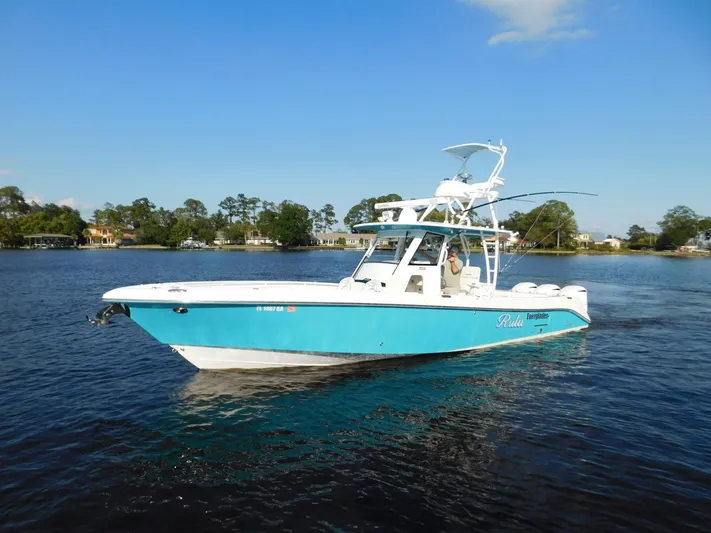  Yacht Photos Pics 2016 Everglades 355 Center Console boat on calm water, clear sky background.
