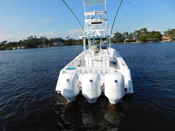  Yacht Photos Pics 2016 Everglades 355 Center Console boat with four outboard engines on a calm lake.