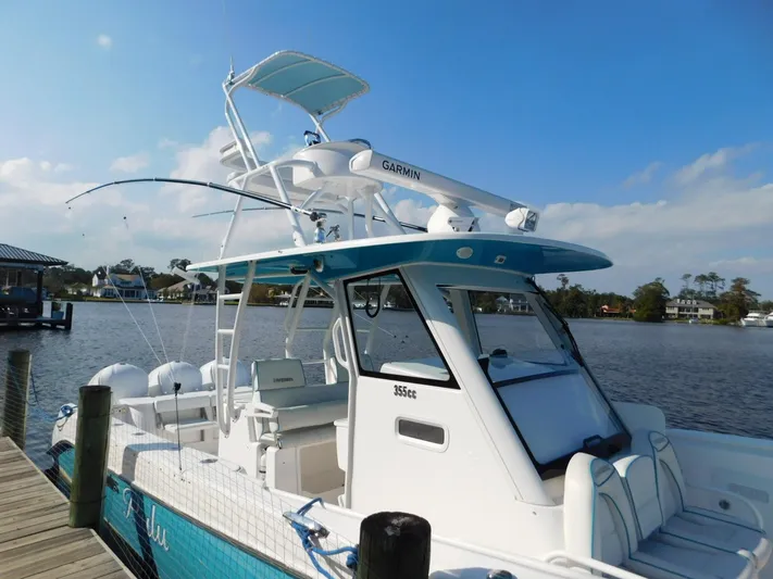  Yacht Photos Pics 2016 Everglades 355 Center Console boat docked by a serene lake.