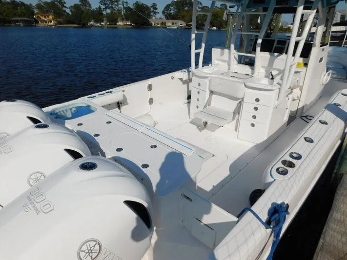  Yacht Photos Pics 2016 Everglades 355 Center Console boat with triple outboard engines on a calm lake.