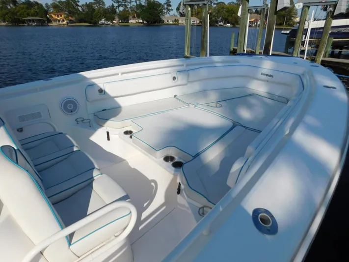  Yacht Photos Pics 2016 Everglades 355 Center Console boat with spacious seating, docked by a serene waterfront.