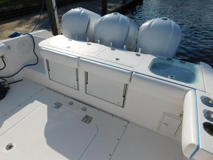  Yacht Photos Pics 2016 Everglades 355 Center Console boat with triple outboard engines docked by water.