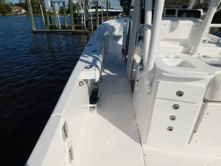  Yacht Photos Pics 2016 Everglades 355 Center Console boat docked by the water, showcasing deck and storage features.