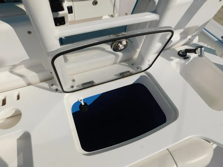  Yacht Photos Pics Open hatch on 2016 Everglades 355 Center Console boat, showcasing storage compartment.