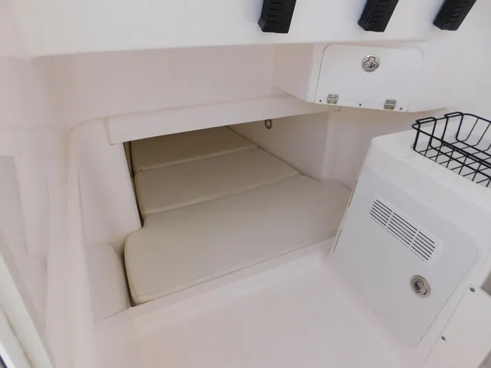  Yacht Photos Pics 2016 Everglades 355 Center Console cabin interior with cushioned seating and storage compartments.