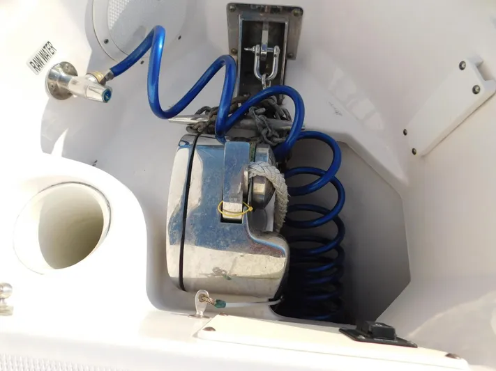  Yacht Photos Pics 2016 Everglades 355 Center Console anchor storage with blue coiled hose and metal fittings.