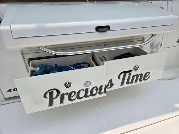 Precious Time Yacht Photos Pics Storage drawers labeled "Precious Time" on a 2017 Sea Ray Sundancer 400 boat.