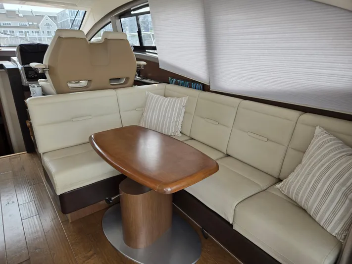 Precious Time Yacht Photos Pics Interior of 2017 Sea Ray Sundancer 400 yacht with beige seating and wooden table.