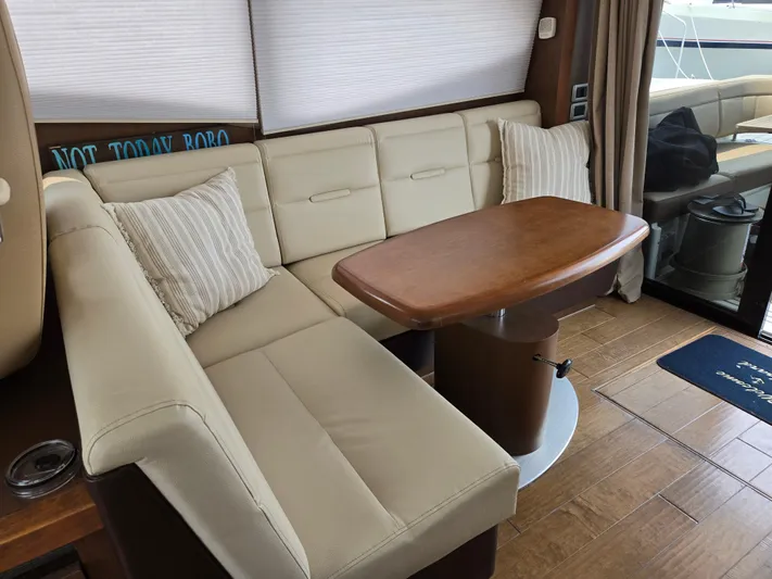 Precious Time Yacht Photos Pics Luxurious interior of 2017 Sea Ray Sundancer 400 with beige seating and wooden table.