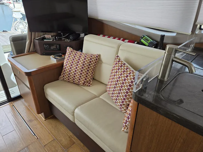 Precious Time Yacht Photos Pics Interior of 2017 Sea Ray Sundancer 400 with beige sofa, patterned cushions, and modern amenities.