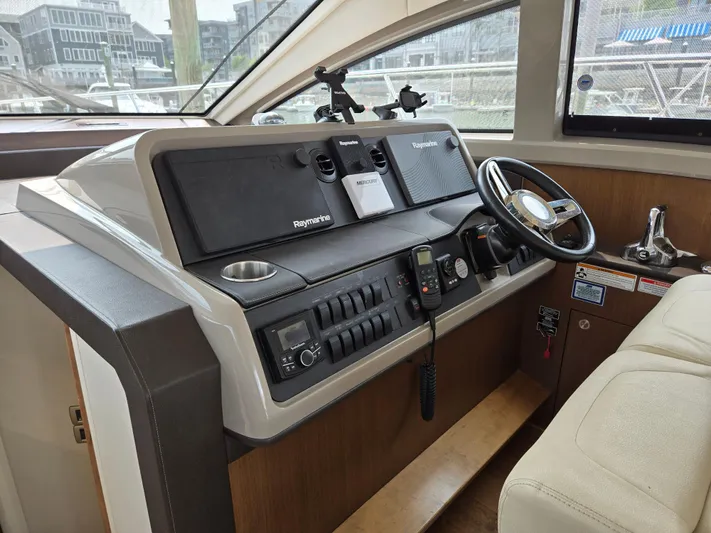 Precious Time Yacht Photos Pics Helm of 2017 Sea Ray Sundancer 400 yacht with modern navigation controls and steering wheel.