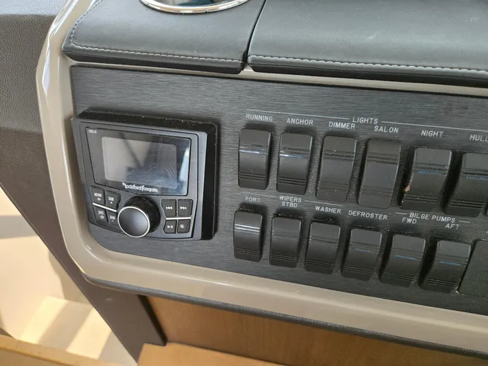 Precious Time Yacht Photos Pics Control panel of a 2017 Sea Ray Sundancer 400 boat with switches and display.