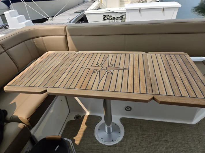 Precious Time Yacht Photos Pics Teak table on 2017 Sea Ray Sundancer 400 yacht with compass rose design.