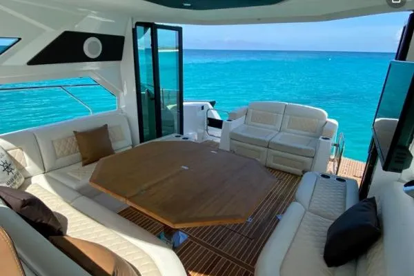 Sol Y Luna Yacht Photos Pics Luxurious 2018 Beneteau 46 yacht interior with ocean view, featuring elegant seating and wooden table.
