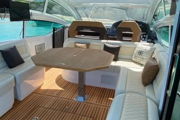 Sol Y Luna Yacht Photos Pics Luxurious interior of 2018 Beneteau 46 yacht with elegant seating and wooden table.