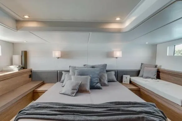 Sol Y Luna Yacht Photos Pics Luxurious interior of 2018 Beneteau 46 yacht with elegant bedding and modern lighting.