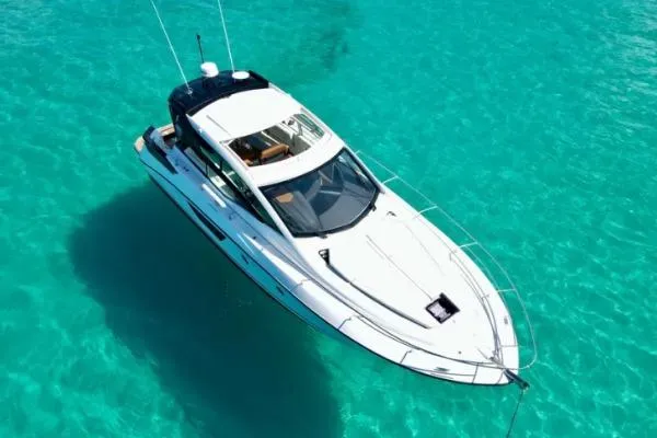Sol Y Luna Yacht Photos Pics 2018 Beneteau 46 yacht on clear turquoise water, aerial view.
