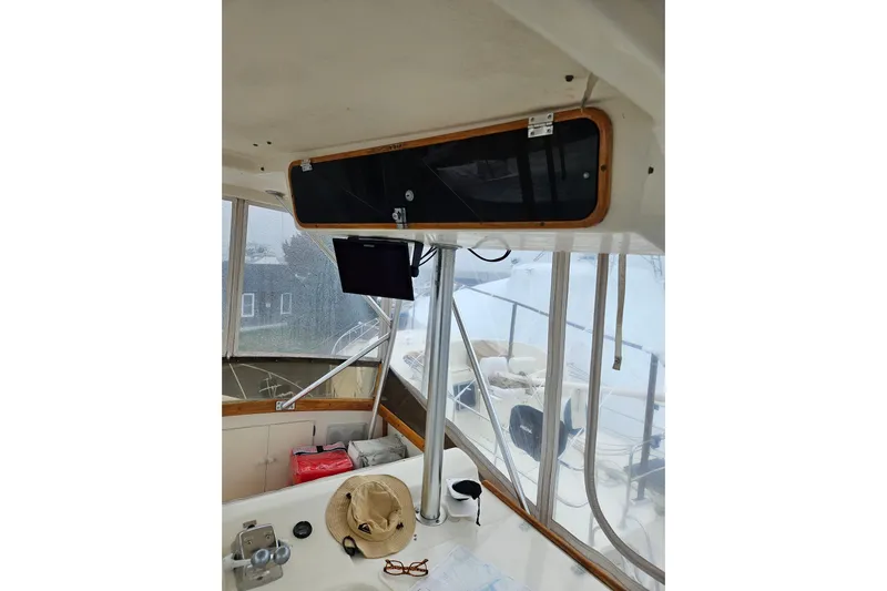  Yacht Photos Pics Interior of 1985 Post 43 Convertible boat with navigation equipment and hat on console.