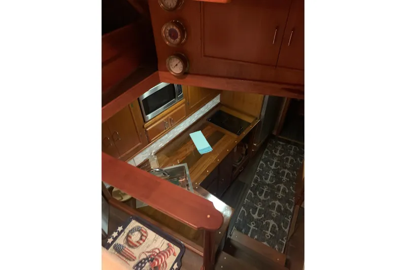 Yacht Photos Pics Interior of 1985 Post 43 Convertible yacht with wooden cabinetry and nautical-themed decor.