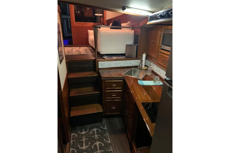  Yacht Photos Pics Interior of 1985 Post 43 Convertible yacht with wooden cabinetry and compact kitchen.