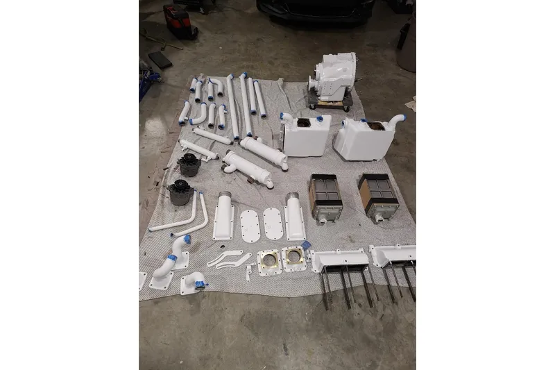  Yacht Photos Pics Assorted white engine parts for 1985 Post 43 Convertible on garage floor.
