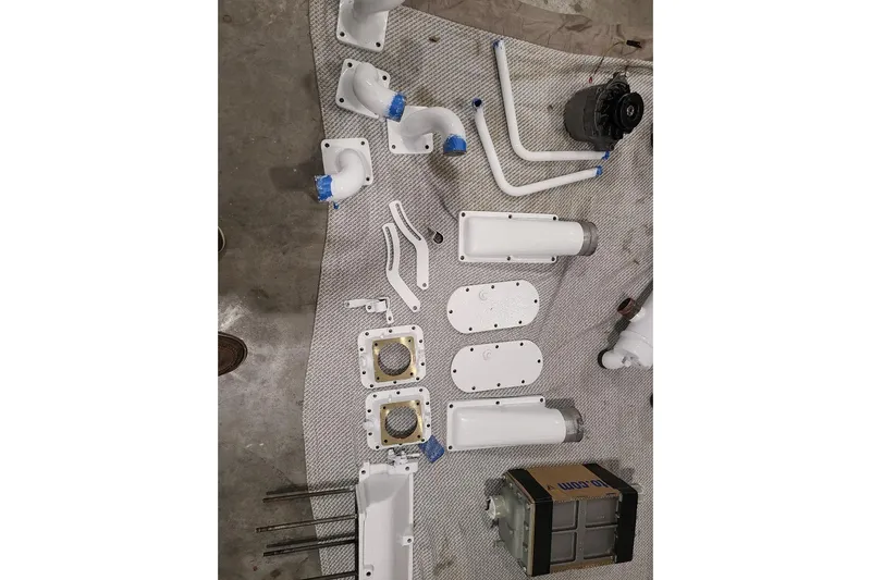  Yacht Photos Pics Assorted white mechanical parts for 1985 Post 43 Convertible on a gray surface.