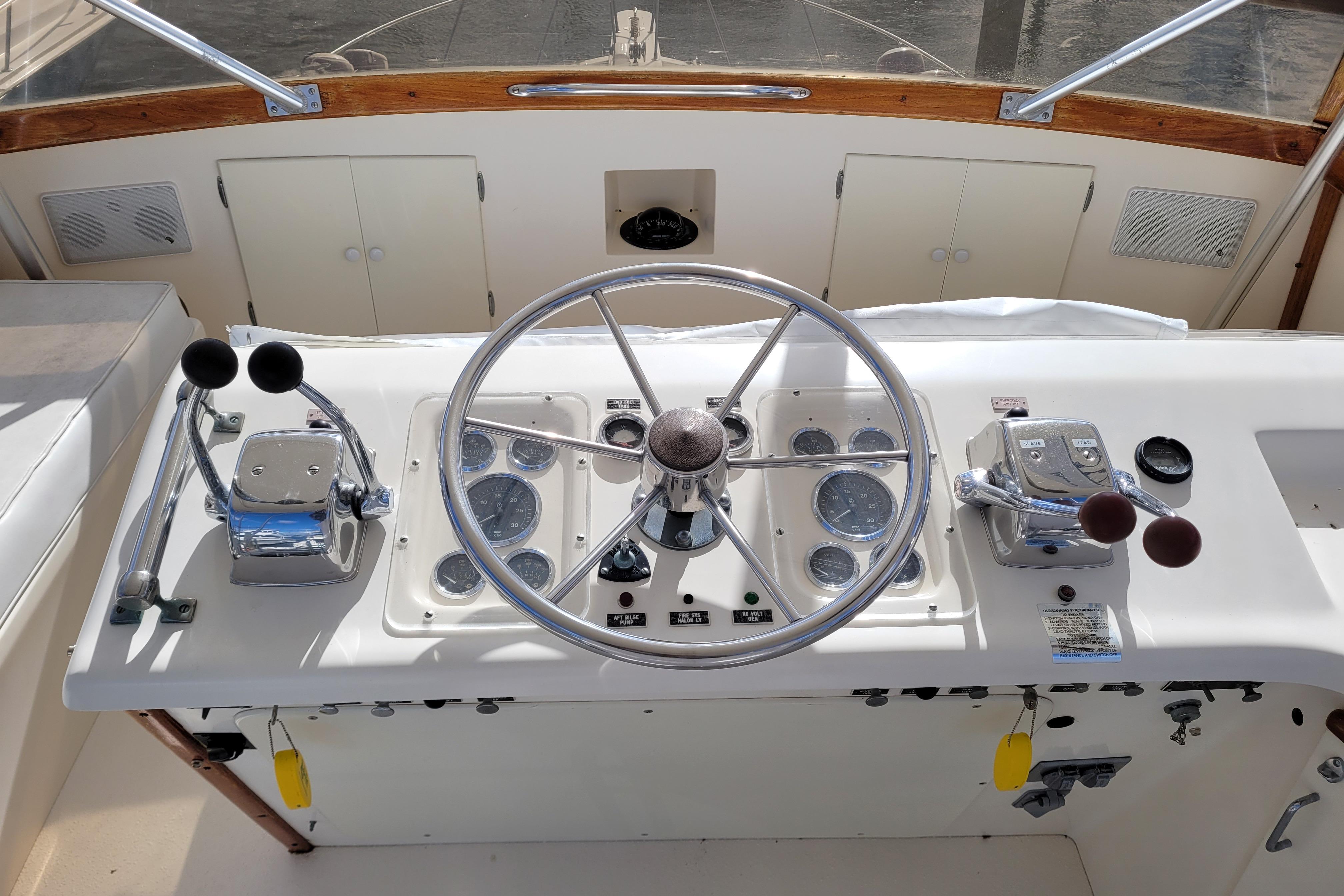 1985 Post 43 Convertible boat helm with steering wheel and control panel.