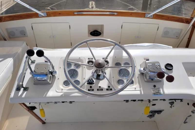  Yacht Photos Pics 1985 Post 43 Convertible boat helm with steering wheel and control panel.