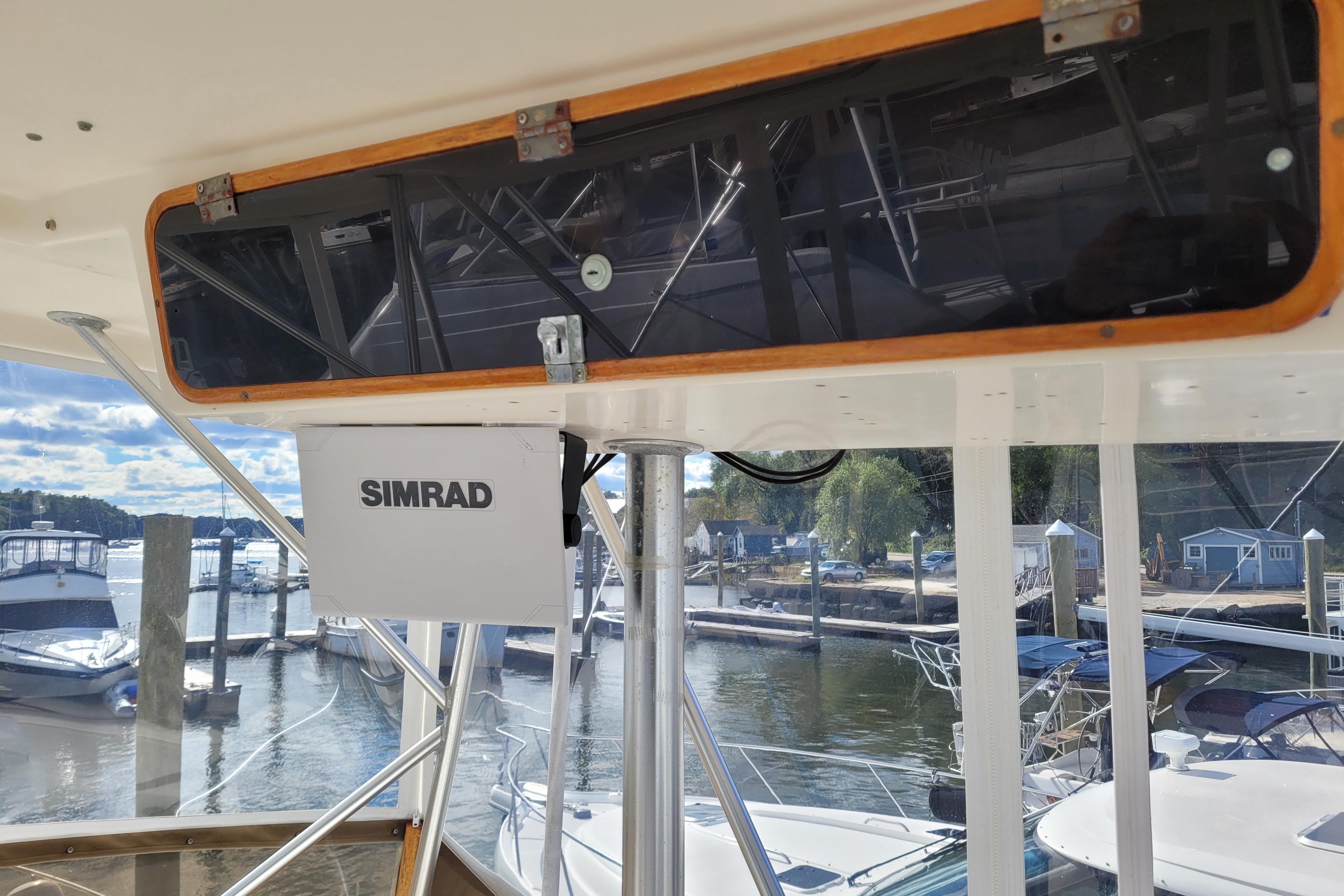 1985 Post 43 Convertible boat with Simrad equipment at a marina dock.