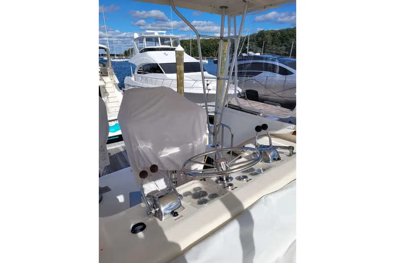  Yacht Photos Pics 1985 Post 43 Convertible yacht helm with marina view, featuring controls and steering wheel.