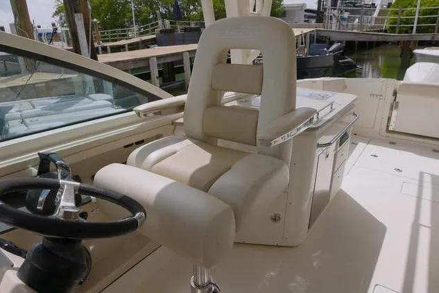  Yacht Photos Pics 2021 Boston Whaler 320 Vantage boat interior with steering wheel and comfortable seating.