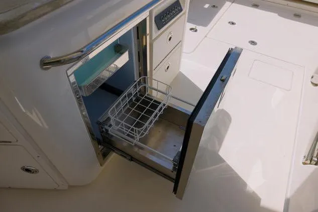  Yacht Photos Pics Open storage compartment on 2021 Boston Whaler 320 Vantage boat, featuring a pull-out drawer.