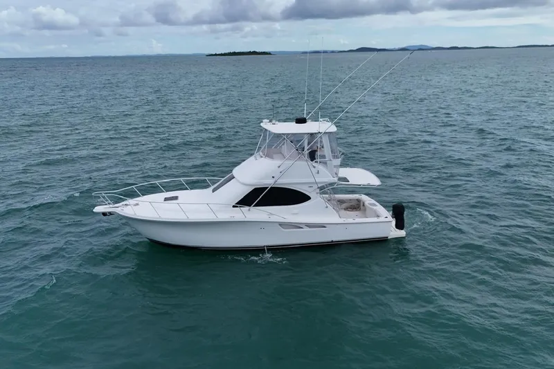  Yacht Photos Pics 2007 Tiara Yachts 3900 Convertible cruising on open water under cloudy skies.