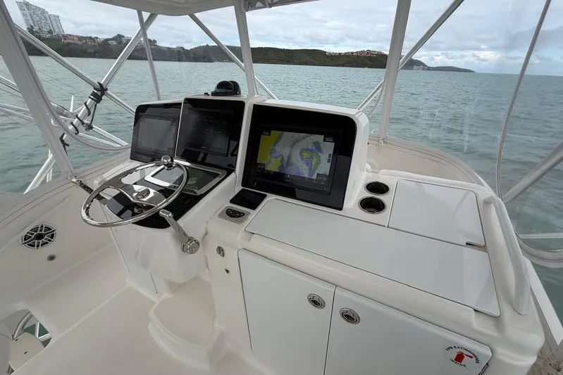  Yacht Photos Pics 2007 Tiara Yachts 3900 Convertible helm with navigation screens, steering wheel, and ocean view.