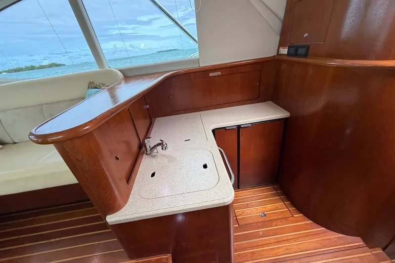  Yacht Photos Pics 2007 Tiara Yachts 3900 Convertible interior with wooden cabinetry and compact kitchenette.