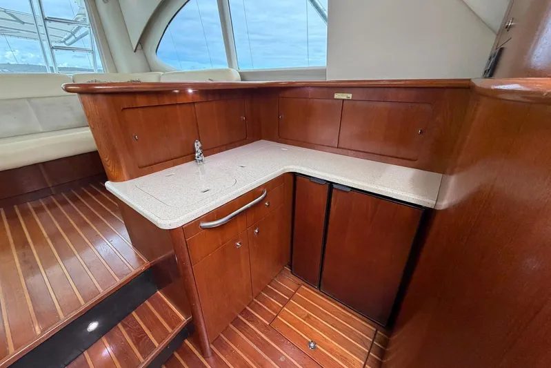  Yacht Photos Pics 2007 Tiara Yachts 3900 Convertible interior with wooden cabinetry and compact kitchenette.