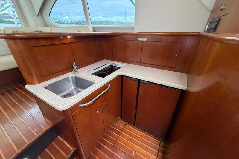  Yacht Photos Pics Luxurious 2007 Tiara Yachts 3900 Convertible galley with wood cabinetry and modern appliances.