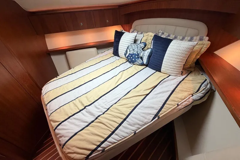  Yacht Photos Pics Luxurious cabin interior of 2007 Tiara Yachts 3900 Convertible with striped bedding.