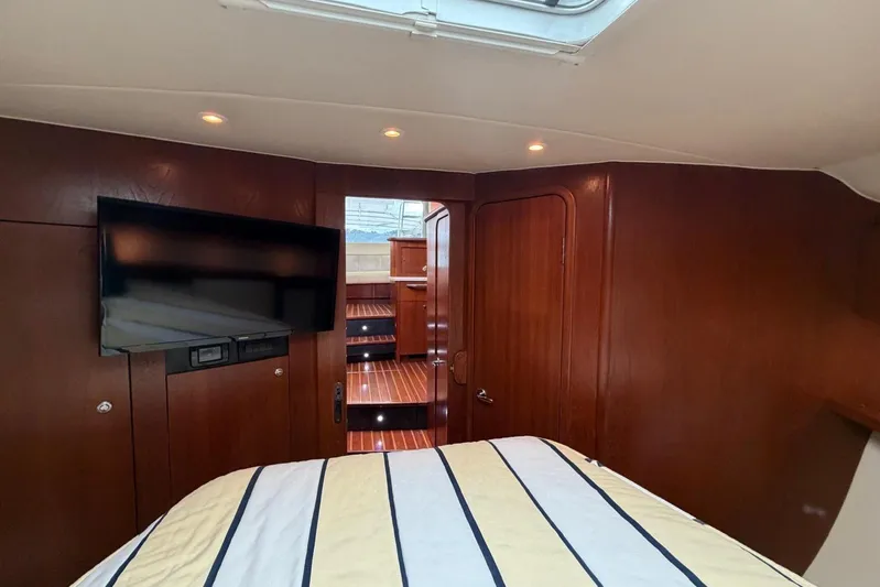  Yacht Photos Pics Luxurious interior of 2007 Tiara Yachts 3900 Convertible with wood paneling and TV.