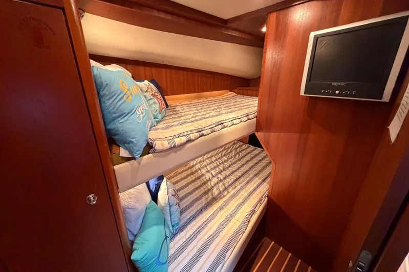  Yacht Photos Pics 2007 Tiara Yachts 3900 Convertible cabin with bunk beds and wall-mounted TV.