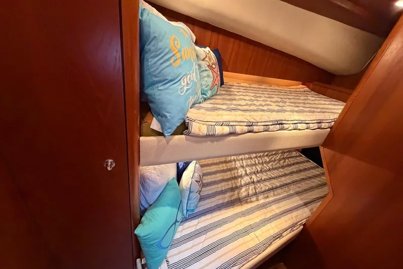  Yacht Photos Pics Bunk beds in 2007 Tiara Yachts 3900 Convertible cabin with striped bedding and decorative pillows.
