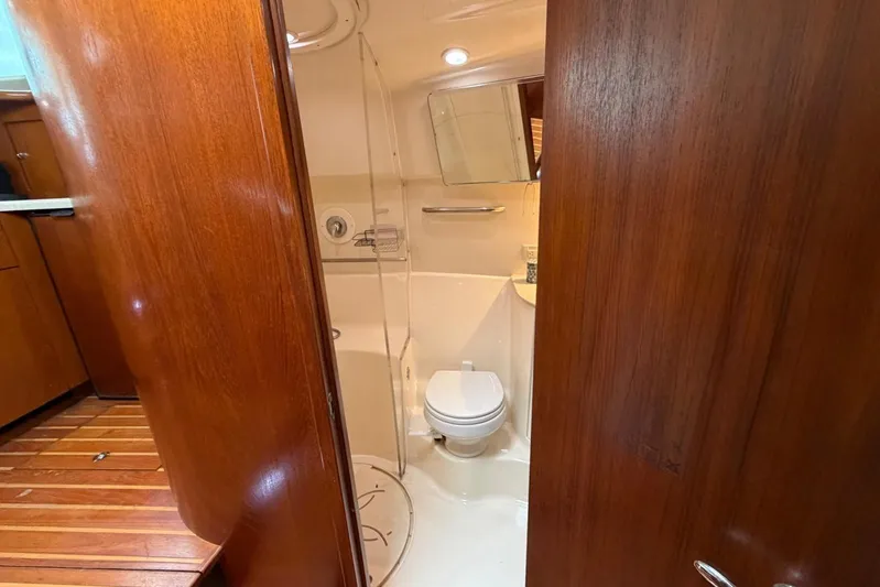  Yacht Photos Pics 2007 Tiara Yachts 3900 Convertible bathroom with wooden interior and compact design.
