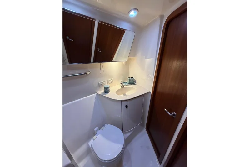  Yacht Photos Pics Bathroom interior of 2007 Tiara Yachts 3900 Convertible, featuring modern fixtures and wooden accents.