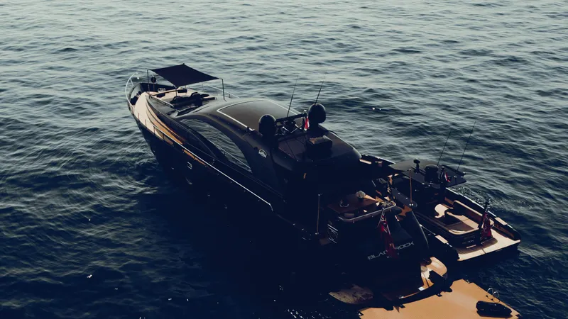 Black Rock Yacht Photos Pics Luxurious Custom 77 yacht from 2008 on calm ocean waters.