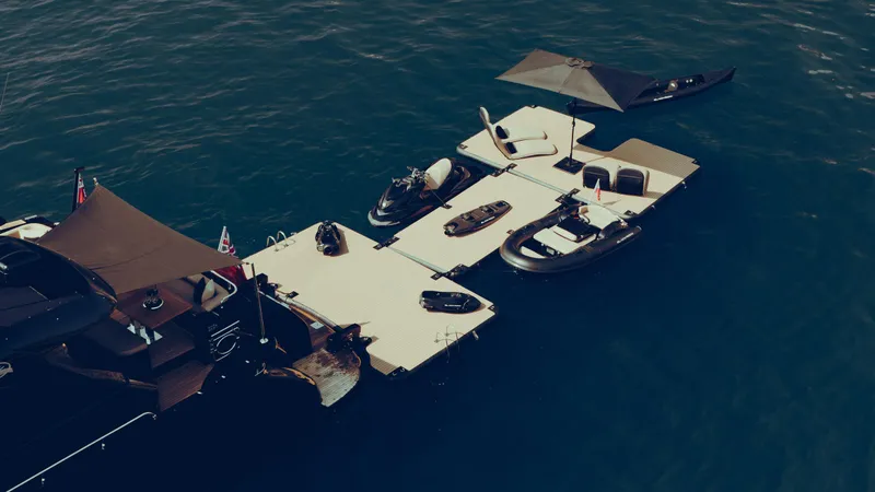 Black Rock Yacht Photos Pics Floating dock with boats and jet skis on calm water, Custom 77 model, 2008.